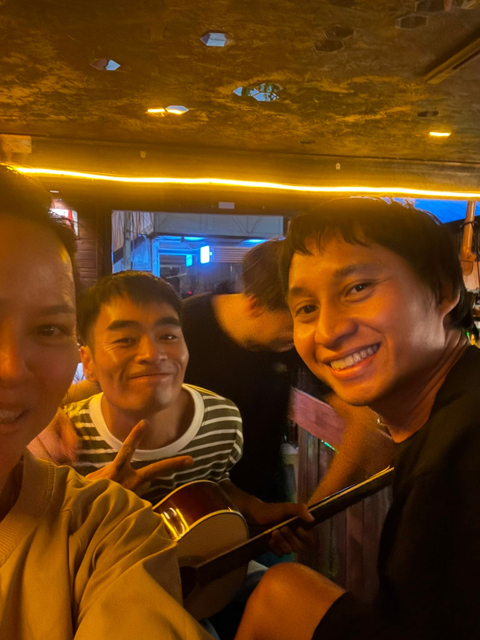 Friends gathered with a guitar at Cafe LungChang