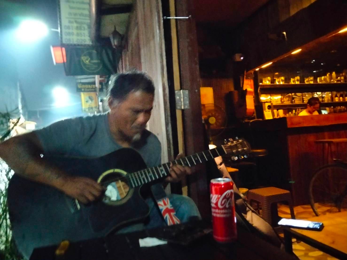 Musician playing guitar at Cafe LungChang