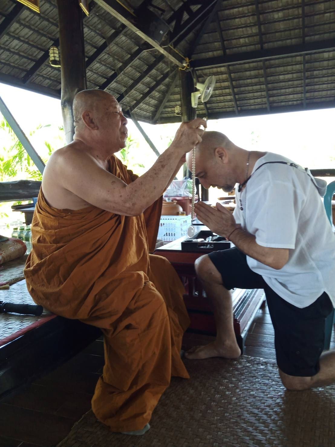Armen Alakheryan receiving a blessing from a Buddhist monk
